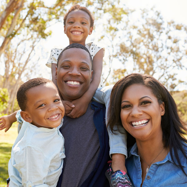 family smiling outdoors