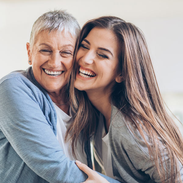 older mom and daughter laughing