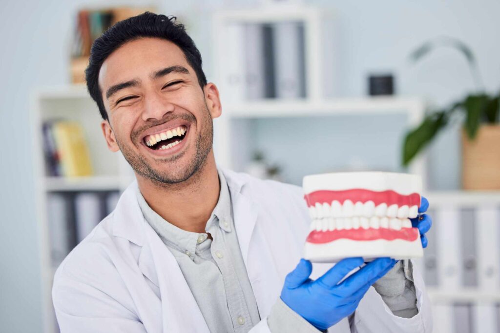 A dentist comparing bonding, veneers, and crown options for smile improvement in Columbus, OH