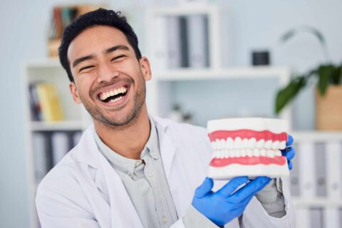 A dentist comparing bonding, veneers, and crown options for smile improvement in Columbus, OH