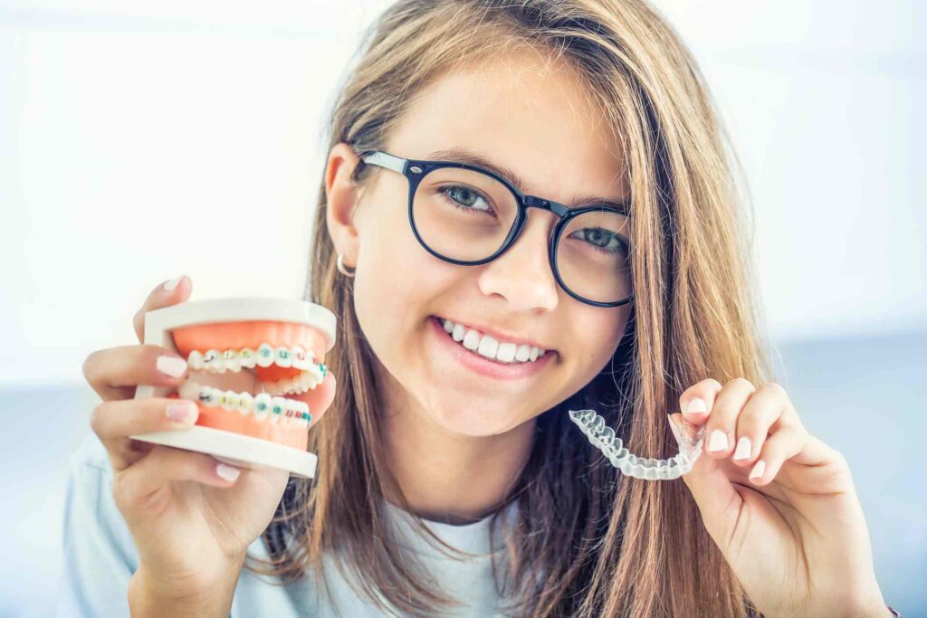 A teen choosing between clear aligners & braces for teeth straightening in Columbus, OH