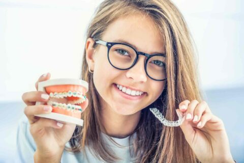 A teen choosing between clear aligners & braces for teeth straightening in Columbus, OH