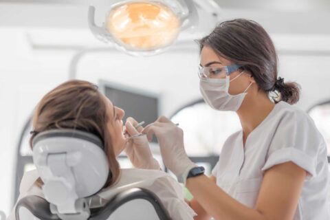 A dentist examining damaged tooth for inlay onlay treatment in Columbus, OH