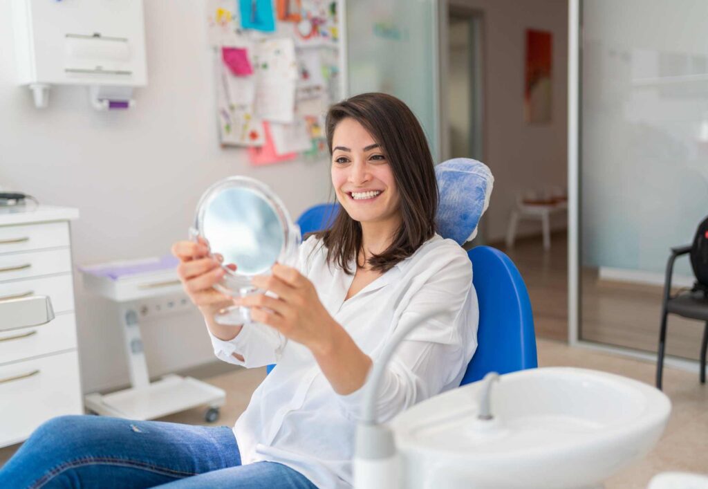 A patient reviewing a brighter smile after professional teeth whitening treatment in Columbus, OH