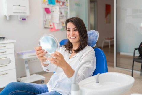 A patient reviewing a brighter smile after professional teeth whitening treatment in Columbus, OH